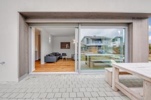 a sliding glass door leading to a living room at Ferienhaus Seebruck in Seebruck