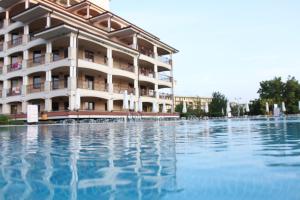 a building with a pool of water in front of it at Casablanca Hotel - All Inclusive in Obzor