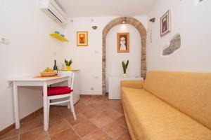 a living room with a couch and a table at Studio May in Piran