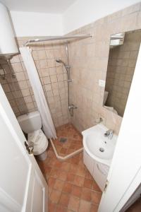 a bathroom with a toilet and a sink at Studio May in Piran