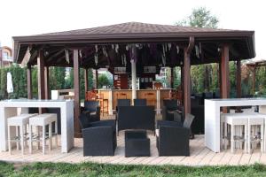 a pavilion with chairs and tables and a bar at Casablanca Hotel - All Inclusive in Obzor