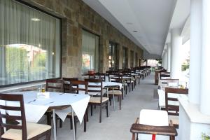 a row of tables and chairs in a restaurant at Casablanca Hotel - All Inclusive in Obzor