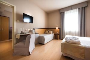 A bed or beds in a room at Hotel San Martino