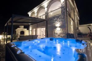 a hot tub in front of a house at night at Dalmata Lounge in Starigrad