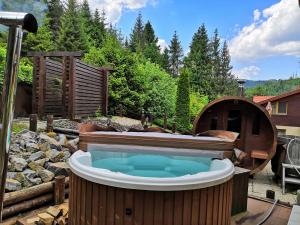 a hot tub in a backyard with a plunge pool at Penzión Pod Guglom in Mlynky 