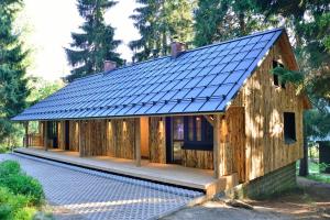 a house with a solar roof on top of it at Montanie Resort in Desná