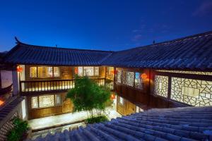 a building with a large staircase in front of it at Xilu Xiaoxie Inn in Lijiang
