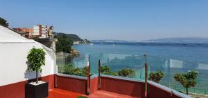 a balcony with a view of a body of water at Casa da Banda in Bueu