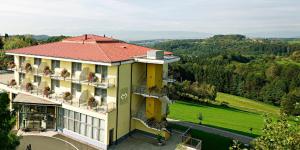 a large yellow building with a red roof at Hotel Liebmann in Lassnitzhöhe