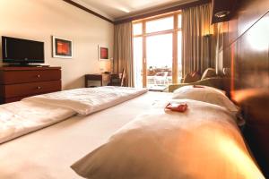 Postel nebo postele na pokoji v ubytování Das Sonnreich - Thermenhotel Loipersdorf