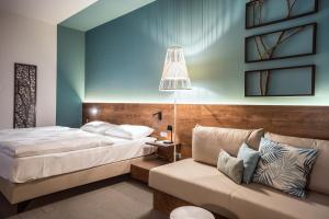 Postel nebo postele na pokoji v ubytování Das Sonnreich - Thermenhotel Loipersdorf