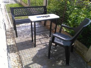 a table and a chair next to a bench at Apartmán GUTINO in Česká Třebová