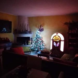 una sala de estar con un árbol de Navidad y una chimenea en B&B Villa Anita, en Bellano