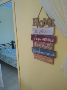 a sign that says love resides in a room at Villa Ladina in Lygia