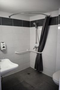 
a bathroom with a shower, toilet and sink at Première Classe Metz Nord - Talange in Talange
