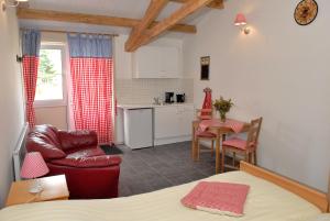 a living room with a bed and a kitchen at Weibos B&B Camperplaats in Schijndel