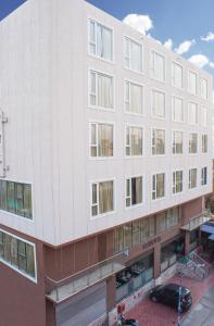 a large white building with many windows at Stayotel Kolkata Airport in Kolkata