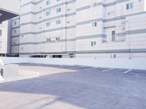 a parking lot in front of a large building at Pohang Brown Dot Hotel in Pohang