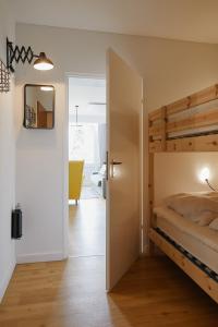 a bedroom with a bunk bed and a mirror at Welcome in - Ferienwohnung 'Tremonia', gegenüber der Piste mit Balkon in Winterberg