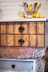 a wooden cabinet with black handles on a kitchen counter at Lemon Tree Stay in Faro