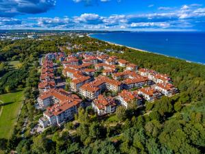 an aerial view of a building with red roofs at Broadway - Neptun Park by OneApartments in Gdańsk