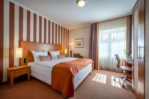 a hotel room with a large bed and a window at Insel Hotel Bonn - Superior in Bonn