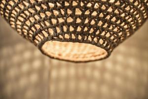 a close up of the back of a wicker chair at Lemon Tree Stay in Faro
