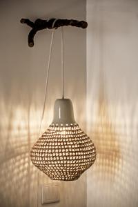 aendant light hanging from a wall in a room at Lemon Tree Stay in Faro