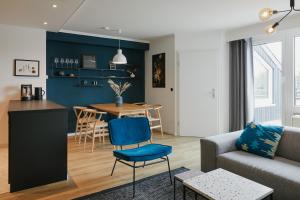 a living room with a couch and a table at Welcome in - Modernes Apartment 70-MA in der Nähe der Skipiste in Winterberg +100 photos