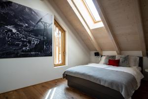 a bedroom with a bed and a large window at Apartment Špica - Private parking in Kranjska Gora