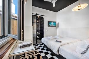 a bedroom with a bed and a checkerboard floor at Lemon Tree Stay in Faro