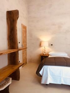 a bedroom with a bed and a wooden shelf at Casa Citta in Brescia +20 photos