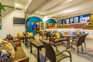 a restaurant with tables and chairs in a room at Fanari Art in Ios Chora