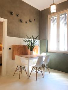 a dining room with a white table and chairs at Casa Citta in Brescia