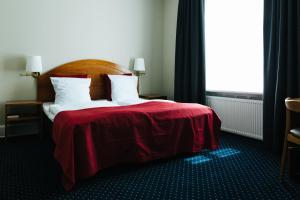Postel nebo postele na pokoji v ubytování City Hotel Nebo