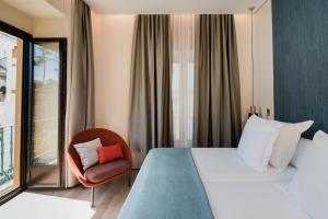 Postel nebo postele na pokoji v ubytování Suites Murillo Plaza Sta. Cruz