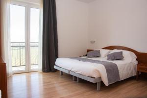 Postel nebo postele na pokoji v ubytování Hotel Nuova Barcaccia