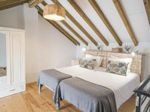 a bedroom with a large bed in a room at Casa Adega Do Mosteiro - Turismo Rural in Caldas da Rainha