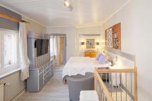 a bedroom with a bed and a sink in a room at Rosenstock Apartments Lüneburg in Lüneburg