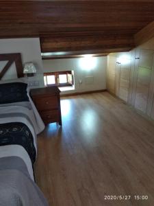 a large room with a bed and a wooden floor at Casa Hortensia in Salas +91 photos