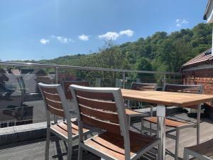 a wooden table and chairs sitting on a deck at School Path Ironbridge Home with Roof Terrace in Ironbridge