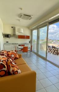 a living room with a couch and a kitchen with a view at Hotel Avana in Riccione