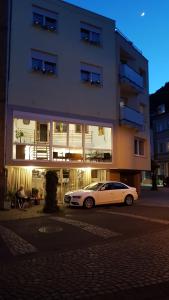 a white car parked in front of a building at Haus Alfina in Alf