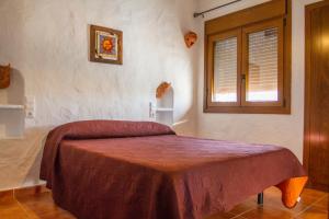 A bed or beds in a room at Casas Rurales La Minilla