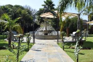 a fountain in the middle of a park at Thabong Bed and Breakfast in Brakpan
