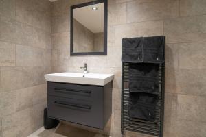 a bathroom with a sink and a mirror at Luxury Coach house next to woodland in Knutsford in Knutsford +45 photos