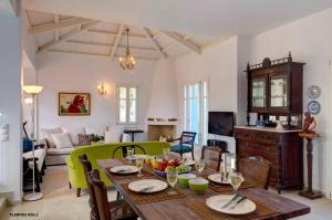 a living room with a wooden table with fruit on it at Planitas Villas in Skopelos Town