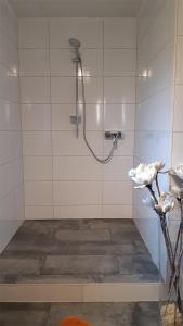 a bathroom with a shower with a hose at Haus Alex in Achenkirch