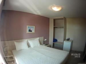 Cama ou camas em um quarto em Rede Andrade Guaíra