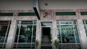 a facade of a building with glass doors at Rede Andrade Guaíra in Curitiba